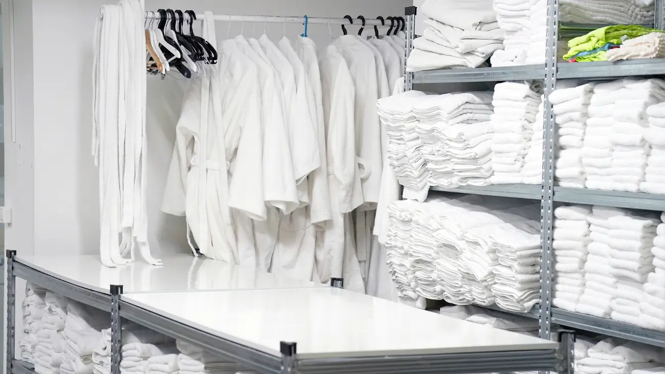 Shelves of clean folded hotel linen and robes
