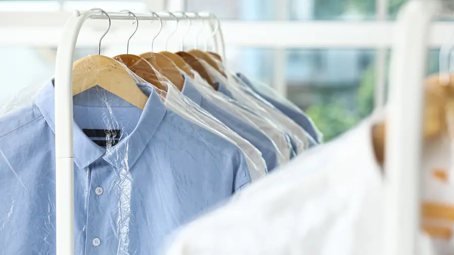 Freshly dry cleaned shirts bagged on a rail